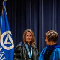 Provost Mili shakes hands